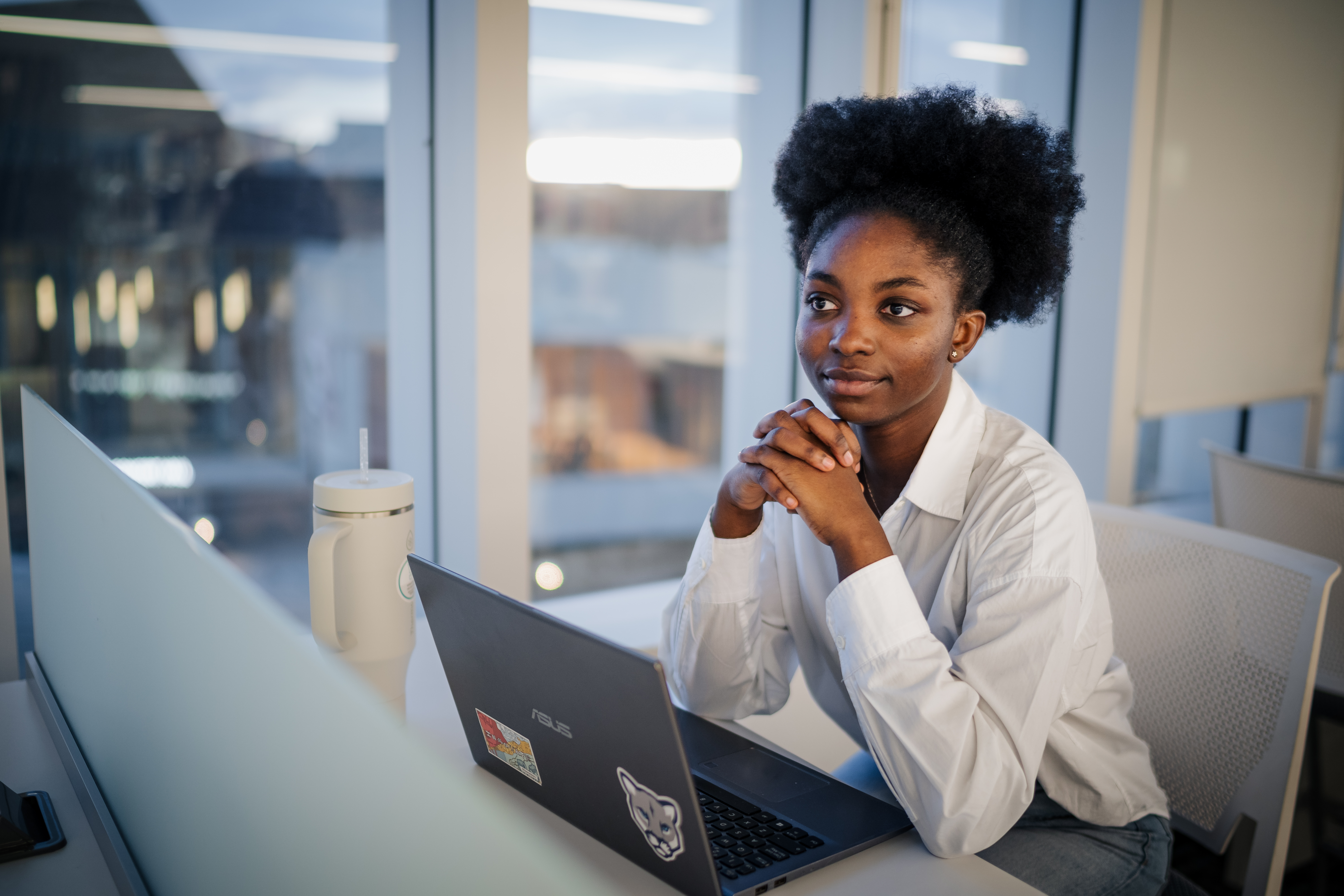 student sitting attentively infront of a laptop